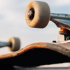 Close-up of a skateboard deck and trucks with a smooth, blurred background, highlighting the beginner-friendly design and sturdy construction, ideal for new riders starting their skateboarding journey.